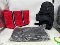 Lot of three women's bags shown on white background: red Nautica tote bag, black crossbody bag, and black Signature Club A tote bag in plastic wrap
