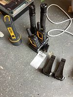 Group shot showing radios in charger, belt clips, flashlights