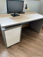 Front view of grey desk, monitor shown for scale not included