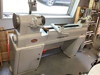 Full view of Powermatic lathe showing headstock, bed, tailstock and cabinet base
