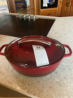 Overall view of red KitchenAid oval roaster with lid