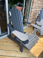 Full view of dark grey resin Muskoka chair on deck