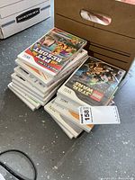 Stack of Wii game cases, two piles showing quantity