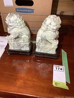 pair of jade foo lion bookends on table