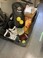 Tote with various sporting goods visible