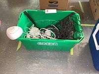 Green tote showing three white D-Link Covr nodes, white cables, black cables