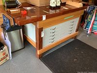 Front view showing wood top, metal drawers and overall construction