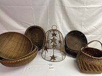 Front view of assorted wicker baskets with metal wire dome featuring star decorations in the center.
