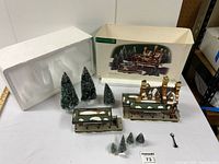 All items shown on table including train station building in two pieces, six miniature trees, small key accessory, and original packaging with foam insert.