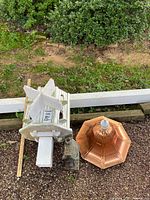 Overhead view showing large wooden birdhouse and copper dome roof side by side on gravel