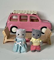 Front view of pink Calico Critters car with two bench seats and cat figures posed