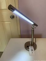 LED desk lamp illuminated on tabletop