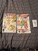 Front covers of both comic books showing issue numbers and title