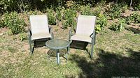 Full view of two chairs and table outdoors