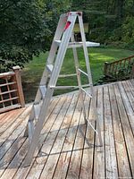 Side view of aluminum A-frame step ladder opened on deck