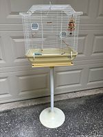 Full view of cage on pedestal stand
