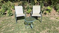 Full set showing two chairs and table outdoors