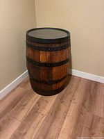 Full view of barrel side table standing on floor