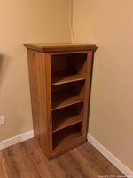 Front view of one bookcase showing shelves and dentil molding