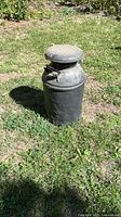 Full view of milk can standing upright outdoors