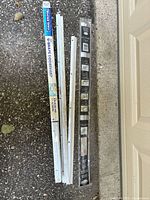 Group of door sweeps and thresholds on ground