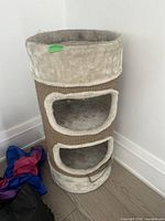 Front view of cylinder cat scratching barrel showing two entry holes and jute exterior