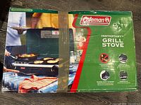 Front of boxed Coleman Instastart Grill Stove