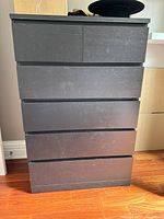 Front view of black laminate 6-drawer dresser