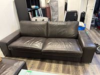 front view of dark brown leather sofa