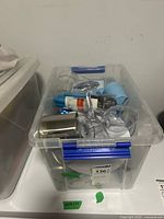 Bin containing assorted picnic tableware