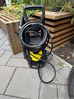 Front view of Vevor pressure washer showing housing, hose, and power connection