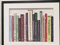 Framed artwork showing cookbook spines within black frame and white mat