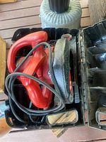 Saw and cord inside open Skil case