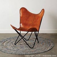 Brown leather butterfly chair with black metal frame