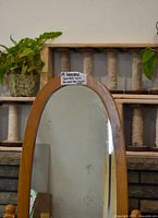 Top portion of oak framed oval mirror
