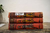 Stack of three red cloth Chums annuals, spine illustrations visible