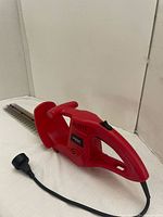 Full view of the Spectra Tools electric hedge/tree trimmer showing the body, handle, blade, and power cord.