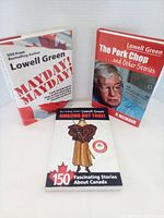 Photo showing three Lowell Green books: 'The Pork Chop and Other Stories' hardcover memoir, 'Mayday Mayday' paperback, and 'Amazing But True' paperback with 150 stories about Canada.