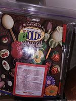 Close up of product packaging showing melt mold gold product with assorted colorful shaped molds and instructions.