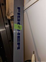 Close-up photo of gray Fischer ski showing brand logo in blue.