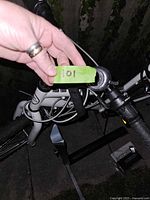 Close-up showing the front frame and part of the handlebar with a green tag labeled '101'.