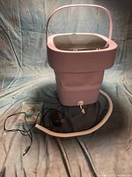 Machine fully extended with hose, power adapter and instruction sheet visible