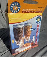 Front of retail box showing image of double cereal dispenser and brand/model information
