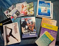 All ten fitness books laid out on blue surface