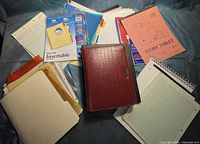 Lot overview with red Day Runner planner, dividers, sheet protectors, assorted paper pads