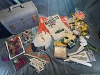 Overview of train case and assorted craft supplies spread out