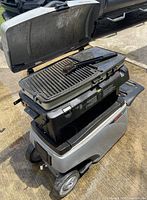 Grill open showing grate, burners and cooler base