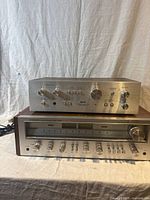 Front view of stacked Akai integrated amplifier on top of Pioneer stereo receiver showing control knobs and front panels.