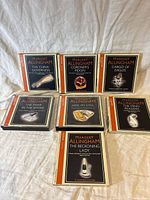 Seven Margery Allingham audio book CD cases arranged in two rows, titles visible on each case, on a white fabric background.