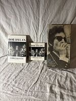 Two hardcover 'Bob Dylan Chronicles' books, one large and one smaller size with black and white cover photos